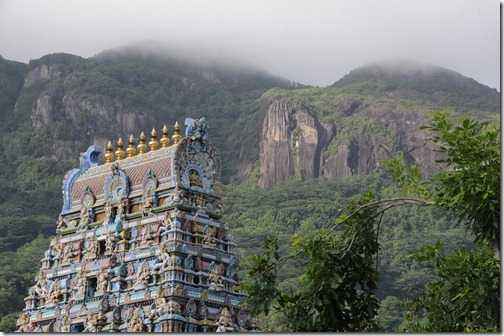 Arulmigu Navasakthi Vinayagar Hindu Temple in Victoria with the granite cliffs of Seychelles in the background