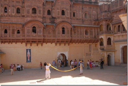 Museum guides demonstrating how to put a turban on at Mehrangarh Fort in Jodphur, Rajasthan, India