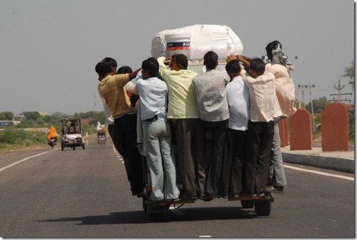An overloaded auto rickshaw speeding down the motorway in Uttar Pradesh, India