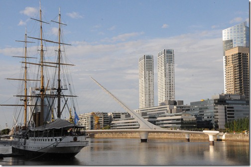 The museum ship 'President Sarmiento' docked in the Puerto Madero district with the Puente de la Mujera (Woman's Bridge) in the background - Buenos Aires, Argentina.