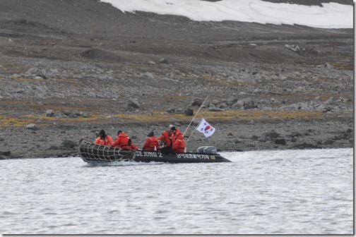 Researchers from the Korean Base, "King Sejong Station" arriving in a Zodiac to the Russian/Chilean stations in Antarctica
