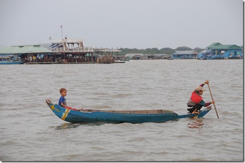 Children fishing in Market in the Floating Village of Chong Kneas on Tonlé Sap lake, Cambodia. Note the Bar/Restaurant in the background that I would end up at.
