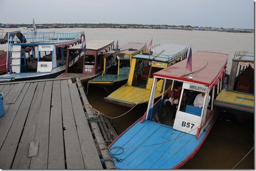 Longboats parked at the bar/restaurant in the Floating Village of Chong Kneas on Tonlé Sap lake, Cambodia.