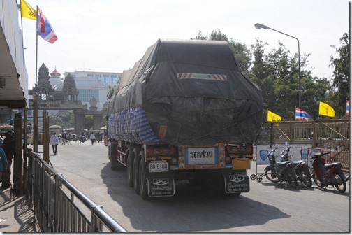 Thai truck moving from the left side to the right side of the road at the border crossing between Thailand and Cambodia