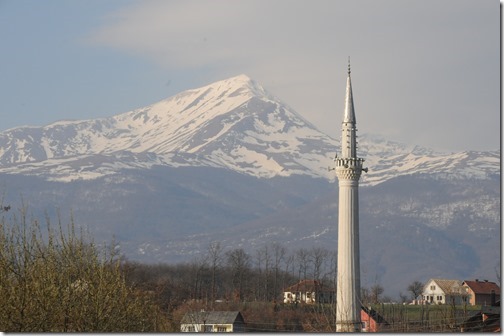 View of a minaret and the Šar (Sharr) Mountains from the train that travels between Pristina, Kosovo to the border with FYRO Macedonia