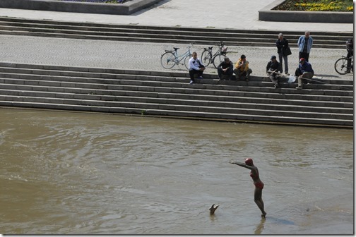 Whimsical statues of women diving into the Vardur River in Skopje, FYRO Macedonia