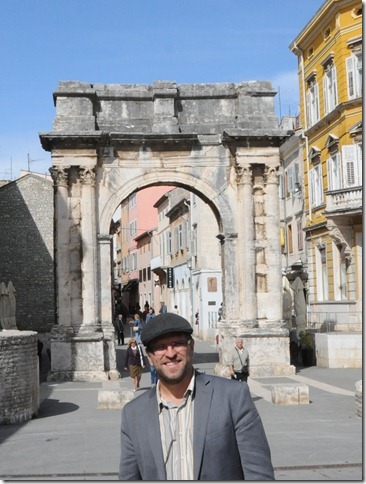 Self-portrait at the Arch of the Sergii, a Roman triumphal arch in Pula, Istria, Croatia