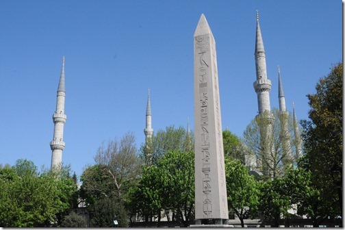 The Obelisk of Thedosius with the minarets of the Sultan Ah in the Ancient Hippodrome of Constantinople (present day Sultan Ahmed (Blue) Mosque in the background in Sultanahmet Mehdani Square in Istanbul, Turkey