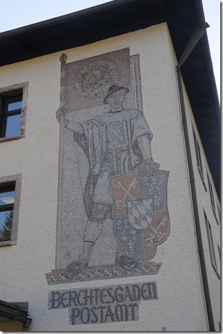 Mural of a Bavarian boy holding a Nazi Flag with the Swastika removed on the Post Office building in Berchtesgaden, Germany