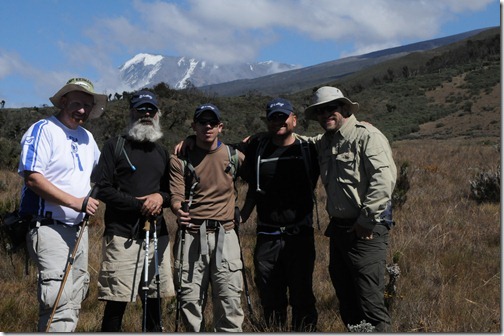 STP Africa team of (left to right) Joel Oleson, Mark Miller, Eric Harlan, Paul Swider, and Michael Noel with Kibo Peak in the background after a successful summit attempt in September, 2012