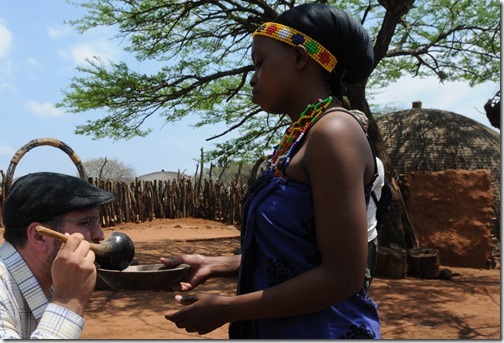 Sampling home-brewed traditional Zulu beer in Shakaland, South Africa