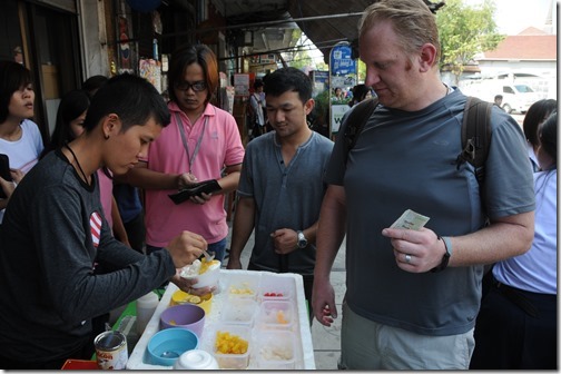 My friend Joel Oleson sampling some of the street food in Bangkok, Thailand
